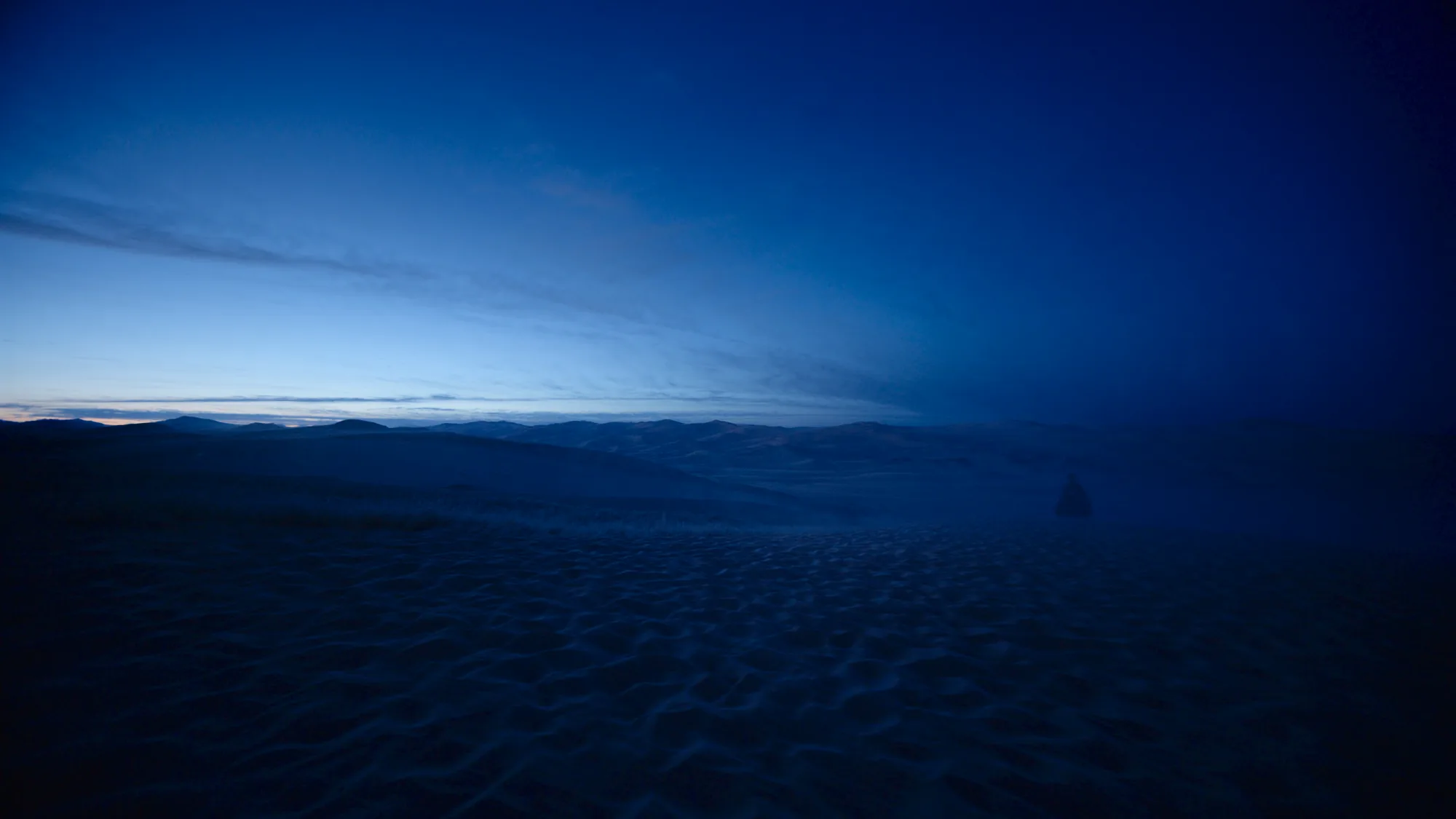 The Mongolian Gobi-Steppe at the cold blue hour, vast and frost-dusted under an obsidian sky